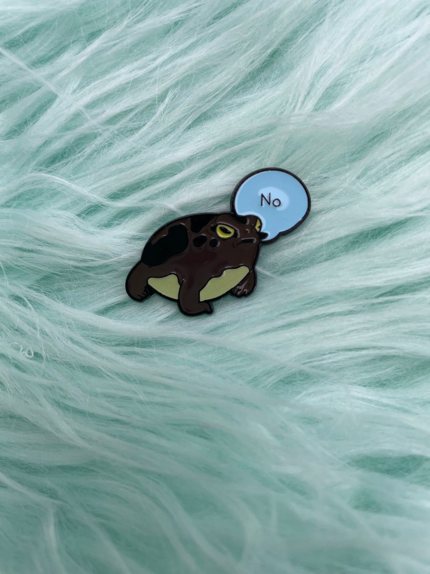 Frog saying no, enamel pin on pink fur