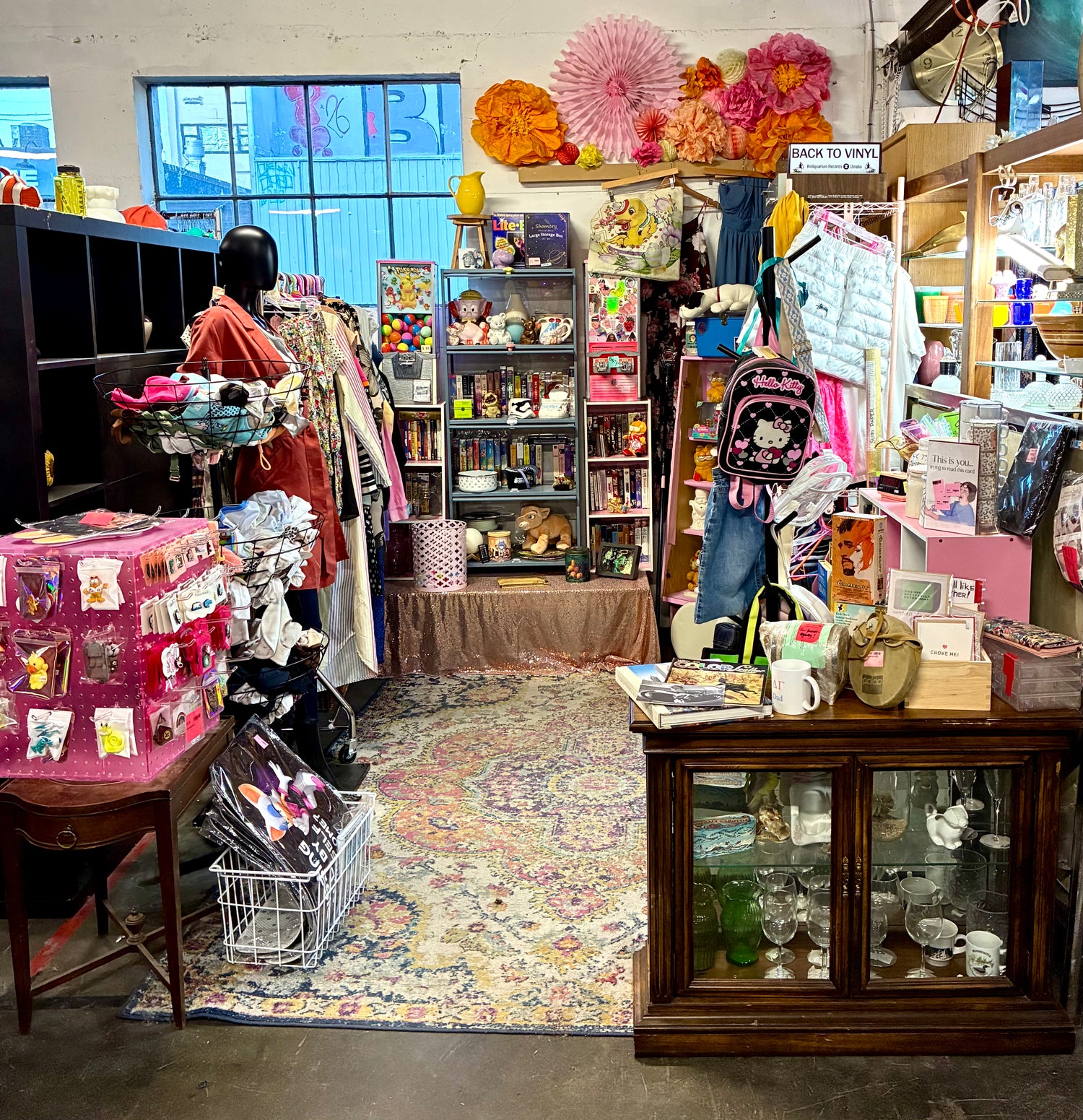 Vintage store interior with various items on shelves and display cases.