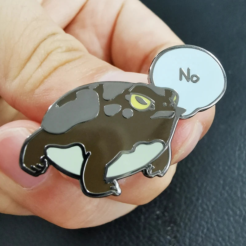 Enamel pin of a panther with a speech bubble saying 'No' held in a hand.