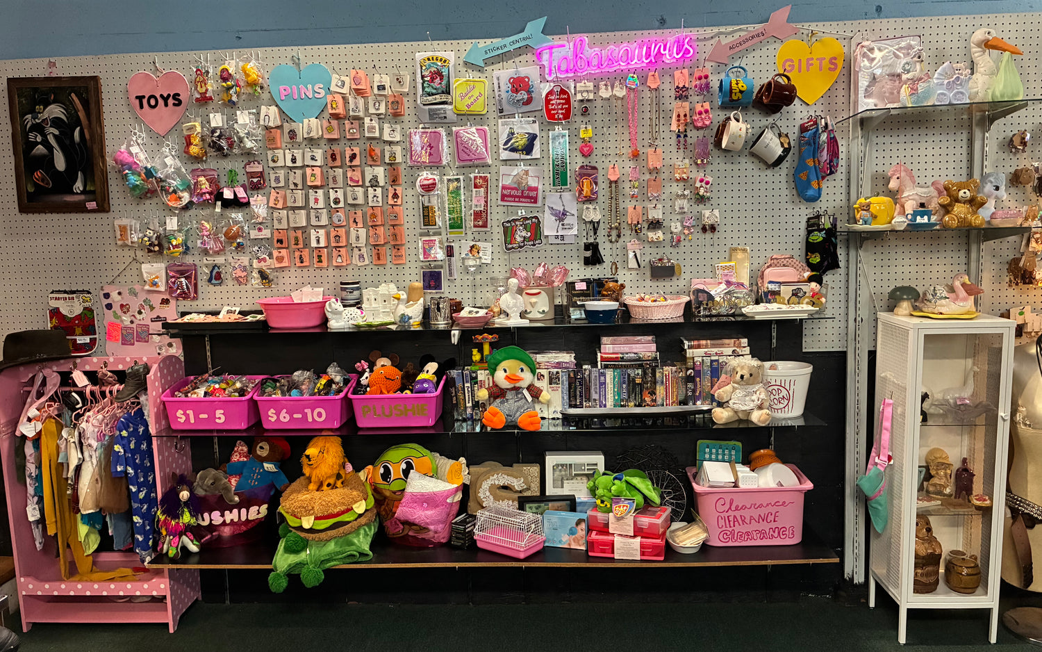 Toy store display with various toys and items on shelves and walls.