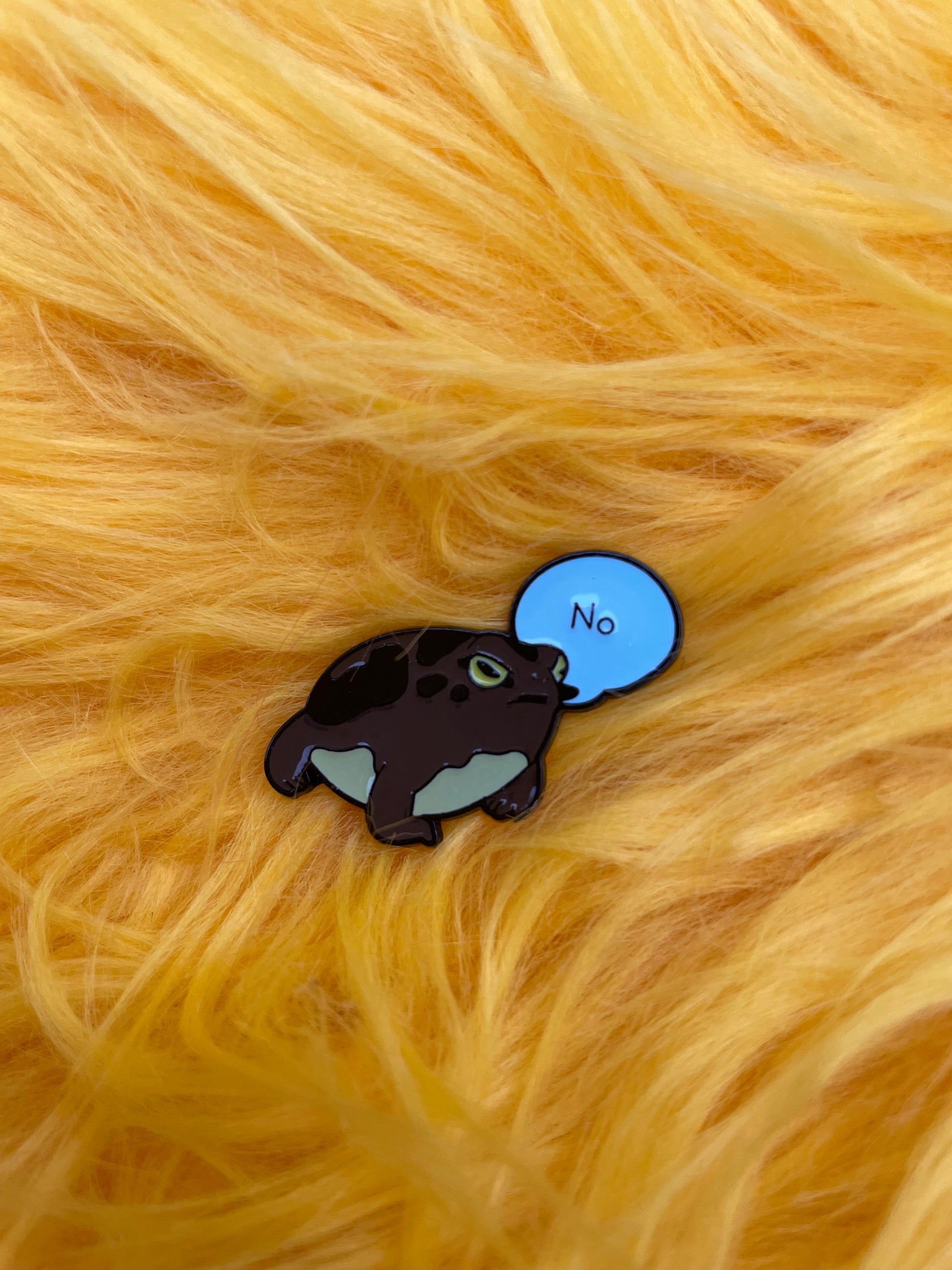 frog saying no, enamel pin, on yellow fur